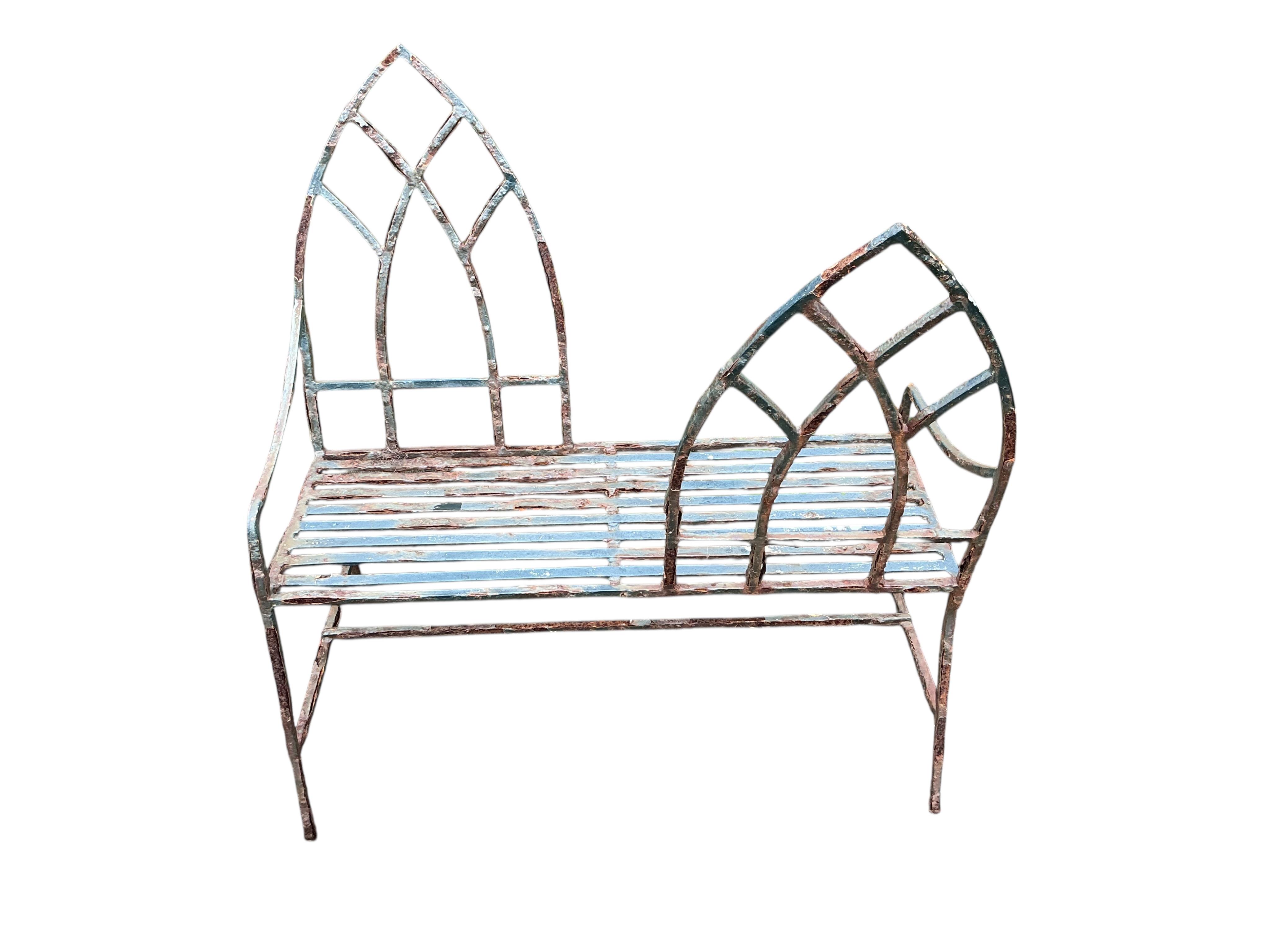 A Gothic style painted wrought iron garden love seat, width 94cm, height 98cm